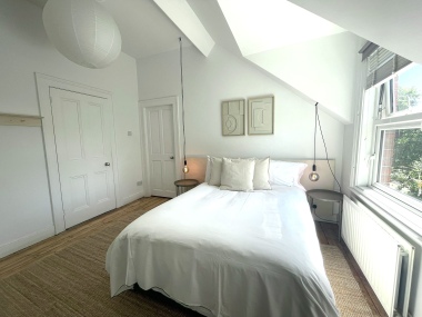 Light-filled double bedroom with skylight and sloped ceiling