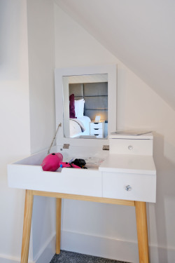 Dressing table and mirror in each room with hairdryer and seat