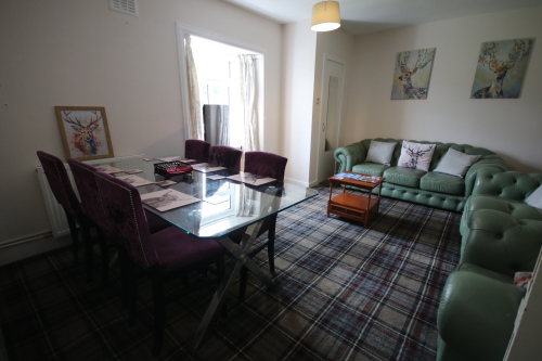Lounge Area with Green Leather Suite