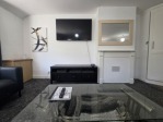 The ultimate entertainment setup. A 55" Smart TV, a comfy sofa bed, dining for 4, and a kitchenette – all in one space.