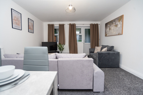 Spacious living area with comfortable sofa beds and flexible seating — perfect for relaxing, socialising, or adding extra sleeping space for larger groups