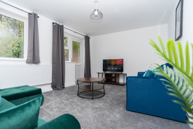 Spacious living room with Full HD Smart TV, super-fast WiFi and comfortable seating — perfect for relaxing, streaming or unwinding after a long day.