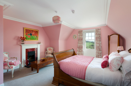 Pink room with king bed and en-suite bathroom