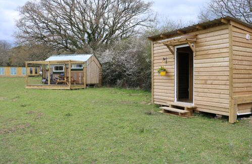 Foreground - toilet and hot shower block, background - The Henhouse glamping hut