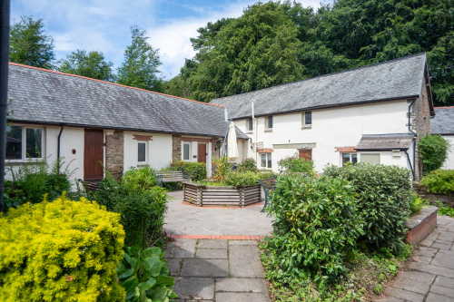 Peaceful Estate Courtyard - Mature gardens and shared seating at the heart of Old Mill Cottages, perfect for soaking up the North Devon countryside between adventures.