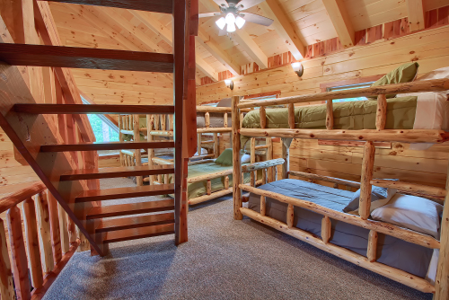 View of Upper Loft cedar stairs and 3 non-private Bunk Sets, from hallway to Bedrooms 4 and 5, Loft Level