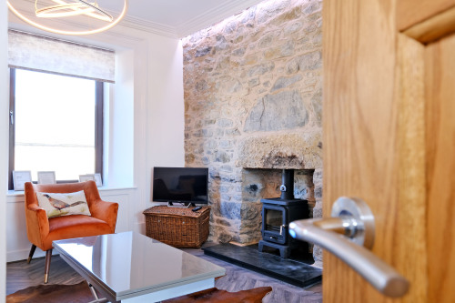 A warm welcome awaits with a wood burning stove and comfy seating