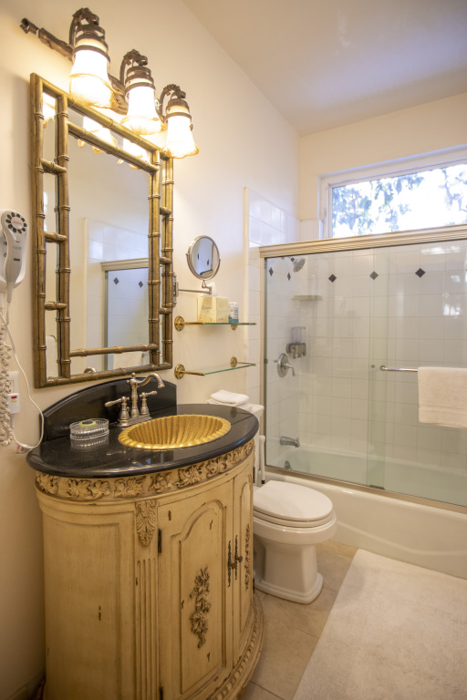 A bathroom with a sink, toilet, shower, and bathtub.