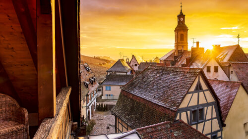 Winter sunrise over the old roofs of Riquewihr, seen from the covered terrace.