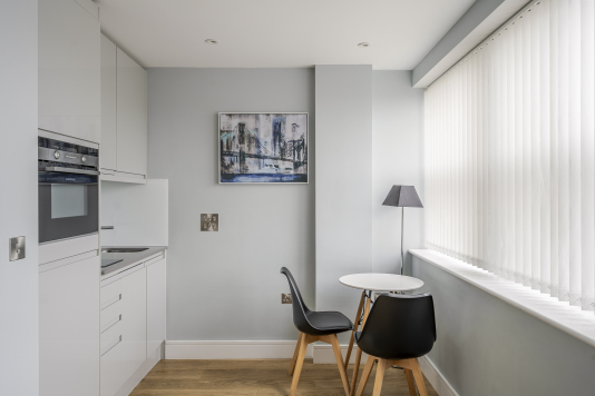 An elegant dining area designed for memorable gatherings, featuring a statement dining table, sophisticated seating, and ambient lighting. This refined space blends style and comfort, perfect for both intimate meals.