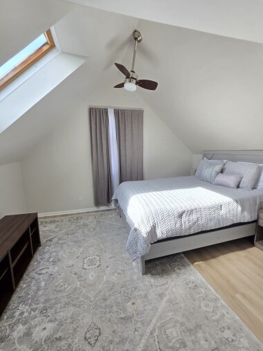 Enjoy a serene view from bed, with a skylight showcasing blue skies during the day and a starry night view in the evening. The 40