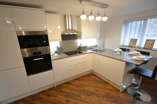 Kitchen with oven, microwave and fridge freezer 