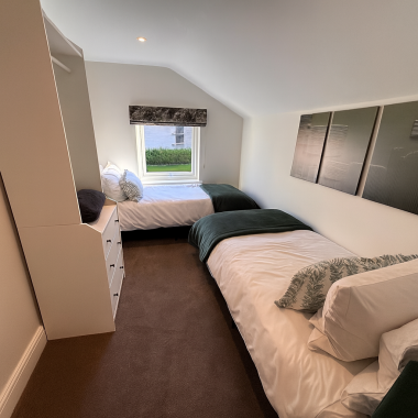 Third bedroom with two full size single beds