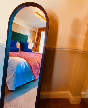 Each room has fluffy pillows, comfortable beds and gorgeous headboards adding a pop of colour.