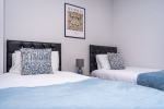 Bedroom with two comfortable single beds, perfect for friends, family, or flexible sleeping arrangements.