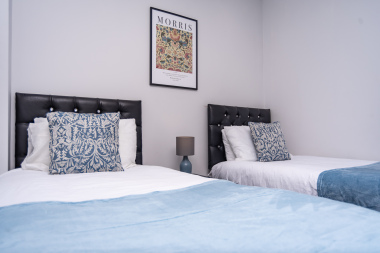 Bedroom with two comfortable single beds, perfect for friends, family, or flexible sleeping arrangements.