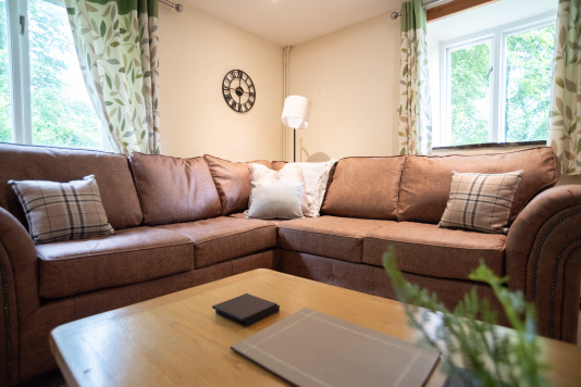 Sink-In Corner Sofa - Plush, hotel-quality comfort for the whole group, with garden views and plenty of room to spread out after a day on the North Devon coast.