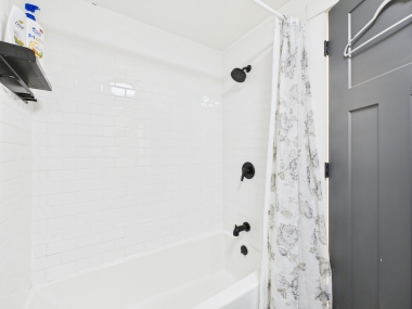 Second bathroom’s walk-in shower—sleek, bright, and always stocked with plush towels.