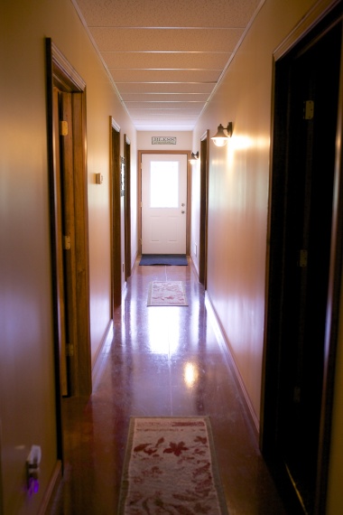 Hallway leading to the bedrooms, bathrooms, and outdoors.