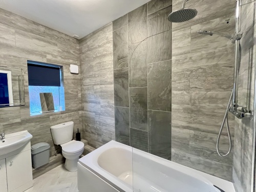 Bathroom - Spacious bathroom featuring a bath over shower, modern space.