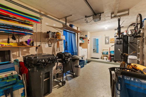 Garage stocked with Beach Equipment and Laundry Room