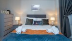 Bright Airy stylish bedroom, with hotel style linens, This room boasts high ceilings and original Cornice and large windows flooding the room with light. A comfortable space to rejuvenate.
