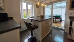 Gather around the island for morning coffee or evening cocktails. Seating for four makes this the heart of the home.