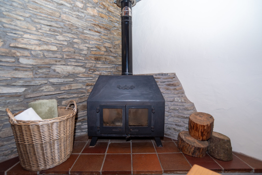 Original Stone Wall & Wood-Burning Stove - Cast iron stove set against the original Devon mill stone wall, perfect for cosy evenings in after a day exploring the coast
