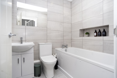 A bright, hotel-style master bathroom fully stocked with essentials for a comfortable stay.