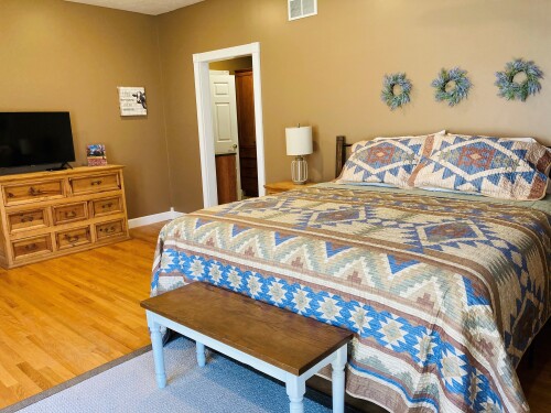 Master bedroom with private bath, walk-in closet, smart TV and access to back deck
