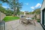 Cedar cottage rear garden terrace with dining and gas BBQ.  Fully enclosed. 