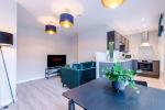 Spacious living room with comfortable seating and inviting atmosphere, perfect for relaxing or socialising during your stay.