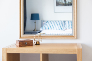 The naster bedroom, has a lovely and classy feel with some modern wallart, bedside lamps and a large built in wardrobe.