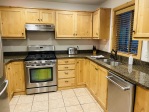 Kitchen with high end furniture. Stainless steel appliances. 