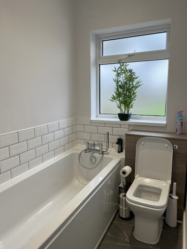 Bathroom with toilet, sink, bath & shower cubicle.