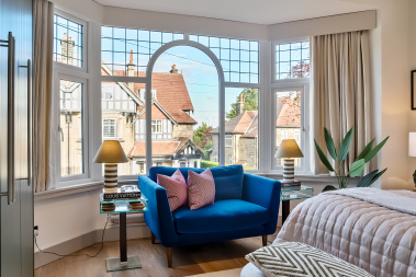 A beautifully styled luxury bedroom with an exceptional view.