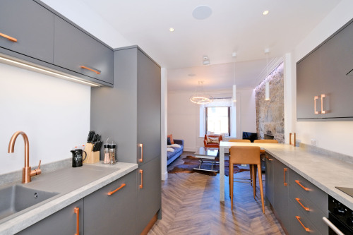 Living area, well-equipped kitchen with breakfast bar, fridge-freezer, dishwasher & induction hob