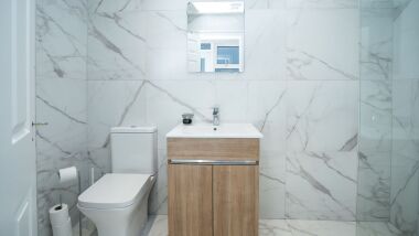 A fresh, modern, fitted bathroom, with a walk in shower. Toiletries and  hotel style towels provided.