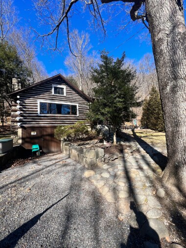 Driveway and steps leadinf to front door.