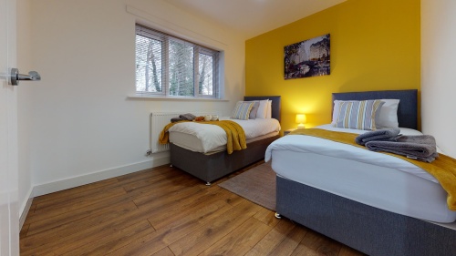 Bedroom 2 with x2 single beds, wardrobe, bedside cabinet and lamp