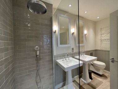 en suite shower room with double sink