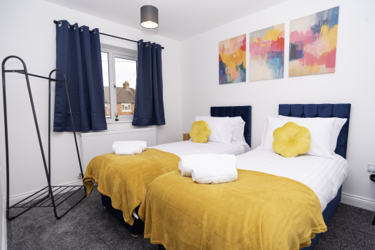 Bright, comfortable bedroom with two single beds - perfect for colleagues, friends or guests needing separate sleeping spaces.