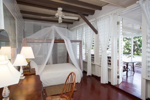 Seaside master bedroom opening onto veranda