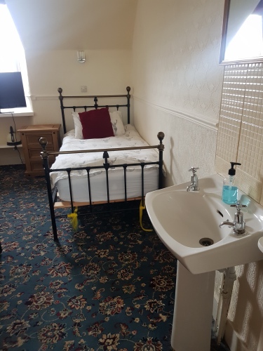 Twin room shares bathroom with one other