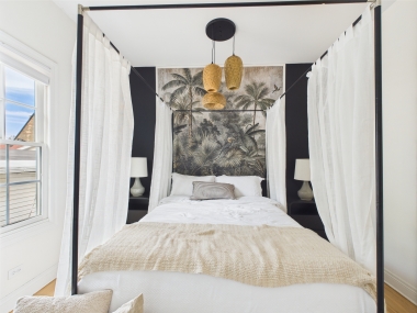 A canopy bed framed by soft textures for restful nights.