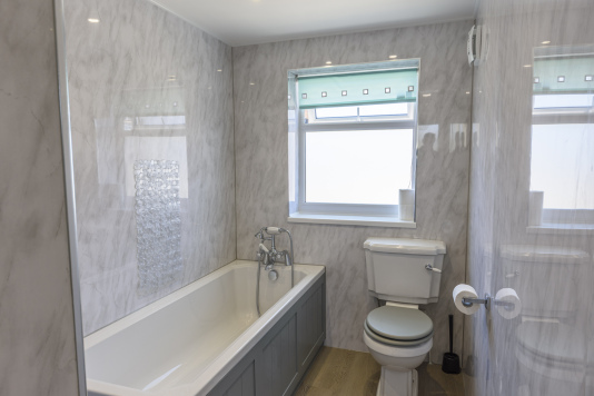 Family bathroom with a large bath
