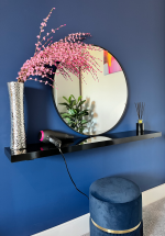Dressing table with large vanity mirror and hairdryer.