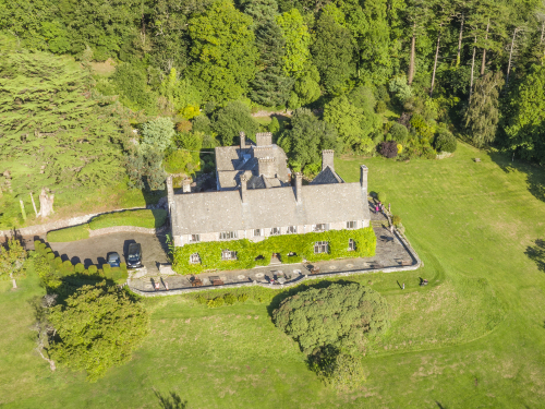 Drone image down of the house, surrounded by lawn