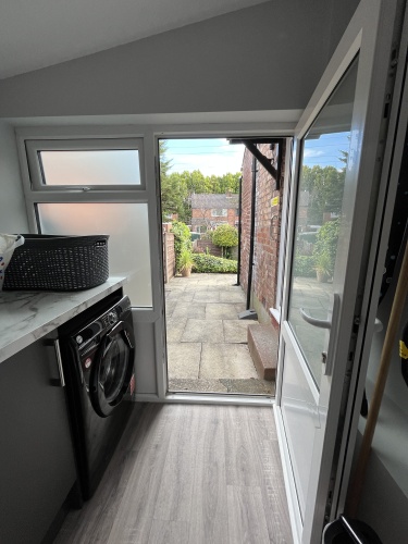 Laundry room - With Washing machine, dryer, iron & ironing board and clothes horse