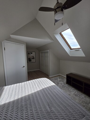 Enjoy a serene view from bed, with a skylight showcasing blue skies during the day and a starry night view in the evening. The 40